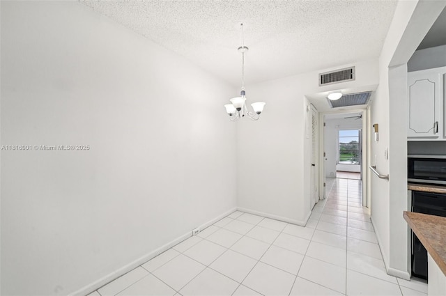 4007 Durham A 4007, Deerfield Beach, FL 33442 - unfurnished dining area with a chandelier, a textured ceiling, baseboards, and light tile patterned flooring