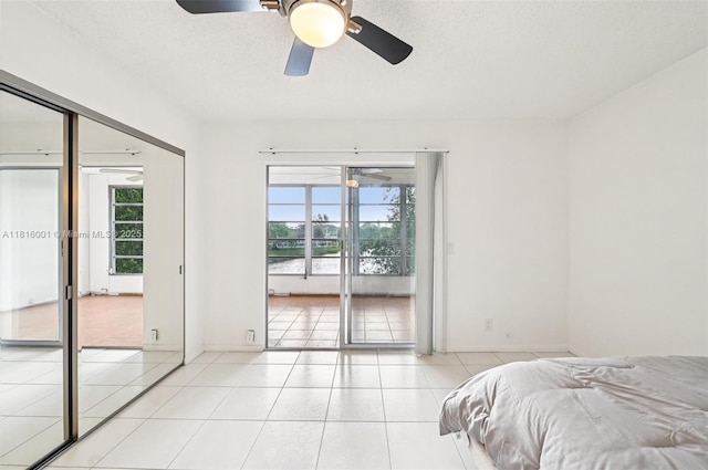 4007 Durham A 4007, Deerfield Beach, FL 33442 - bedroom featuring tile patterned flooring, ceiling fan, access to exterior, and a textured ceiling