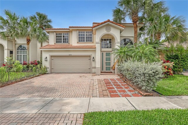 12173 Colony Preserve Dr, Boynton Beach, FL 33436 - mediterranean / spanish house with decorative driveway, stucco siding, an attached garage, and a tile roof