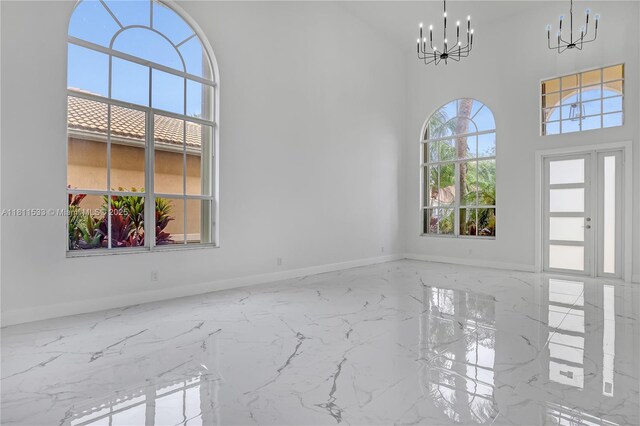 12173 Colony Preserve Dr, Boynton Beach, FL 33436 - empty room featuring a chandelier, marble tiled flooring, and a towering ceiling