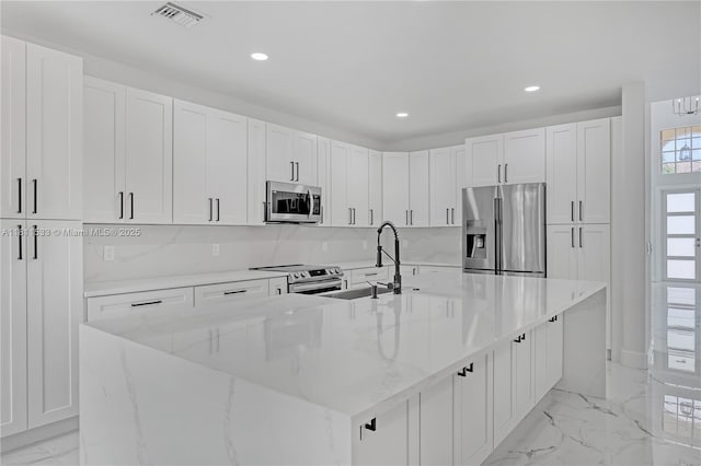12173 Colony Preserve Dr, Boynton Beach, FL 33436 - kitchen with appliances with stainless steel finishes, light marble finish floors, recessed lighting, a large island, and white cabinets