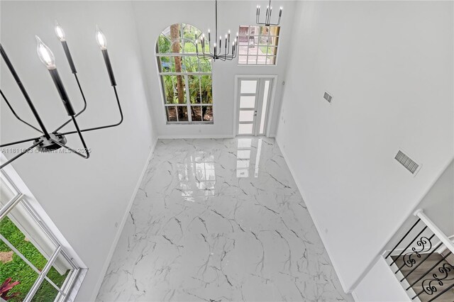 12173 Colony Preserve Dr, Boynton Beach, FL 33436 - foyer featuring a chandelier, marble tiled floors, plenty of natural light, and a high ceiling
