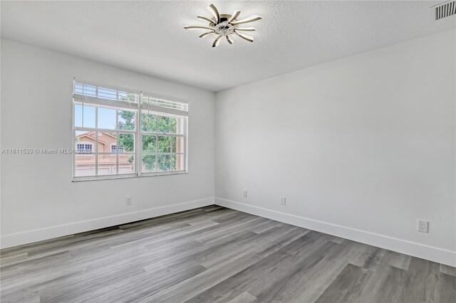 12173 Colony Preserve Dr, Boynton Beach, FL 33436 - spare room featuring wood finished floors, a ceiling fan, and a textured ceiling