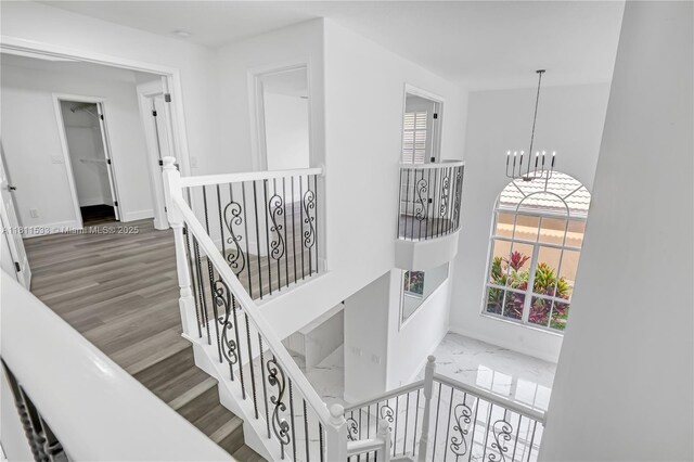 12173 Colony Preserve Dr, Boynton Beach, FL 33436 - stairway featuring healthy amount of natural light, a chandelier, and wood finished floors