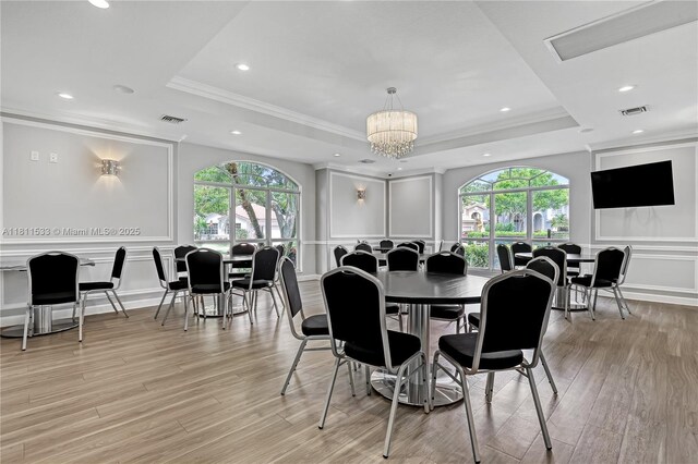 12173 Colony Preserve Dr, Boynton Beach, FL 33436 - dining space featuring a tray ceiling, a decorative wall, plenty of natural light, crown molding, and light wood-style flooring