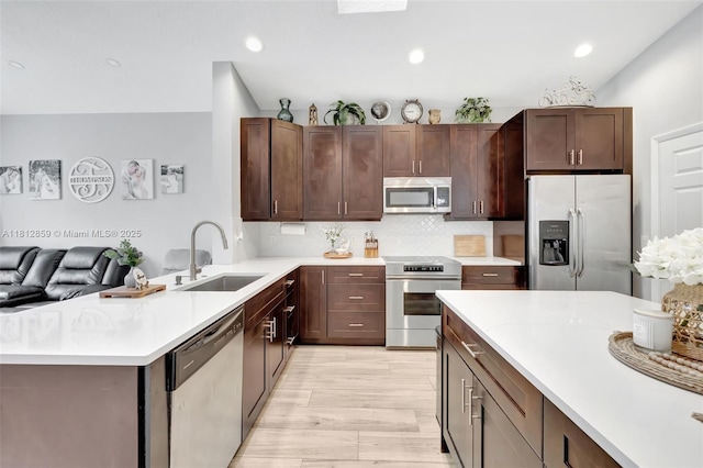 3059 Dogwood Ln, Margate, FL 33063 - kitchen with stainless steel appliances, a sink, light countertops, backsplash, and recessed lighting