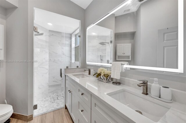 3059 Dogwood Ln, Margate, FL 33063 - full bath with a stall shower, toilet, double vanity, wood finished floors, and baseboards