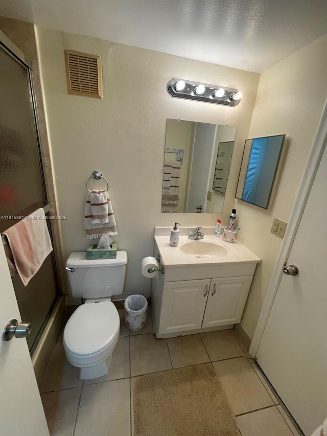 7740 Camino Real Unit G-305, Miami, FL 33143 - full bath with a shower with shower door, vanity, tile patterned floors, and toilet