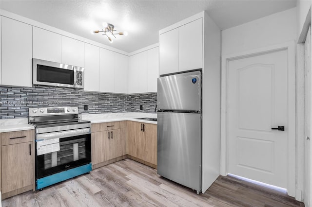 19330 NE 2nd Ave, Miami, FL 33179 - kitchen with stainless steel appliances, light countertops, and light wood-type flooring