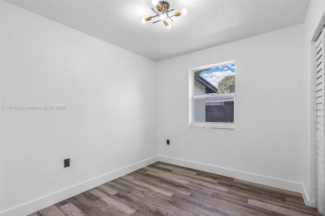 19330 NE 2nd Ave, Miami, FL 33179 - spare room featuring a chandelier, baseboards, and wood finished floors