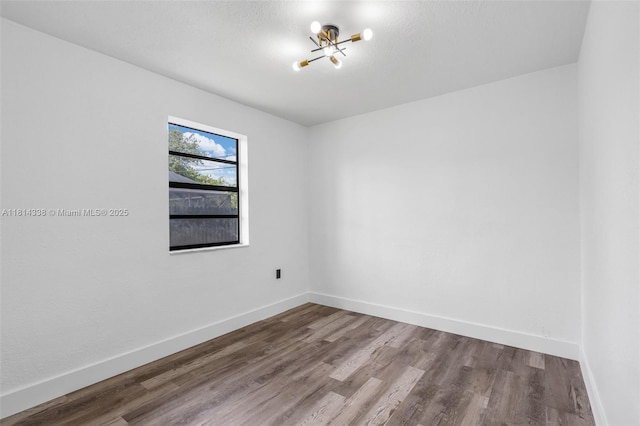 19330 NE 2nd Ave, Miami, FL 33179 - spare room featuring wood finished floors, a chandelier, and baseboards