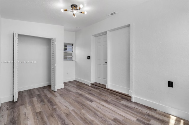 19330 NE 2nd Ave, Miami, FL 33179 - unfurnished bedroom with wood finished floors, a chandelier, and baseboards