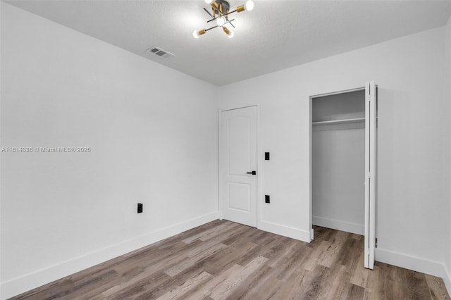 19330 NE 2nd Ave, Miami, FL 33179 - unfurnished bedroom with wood finished floors, baseboards, and a closet