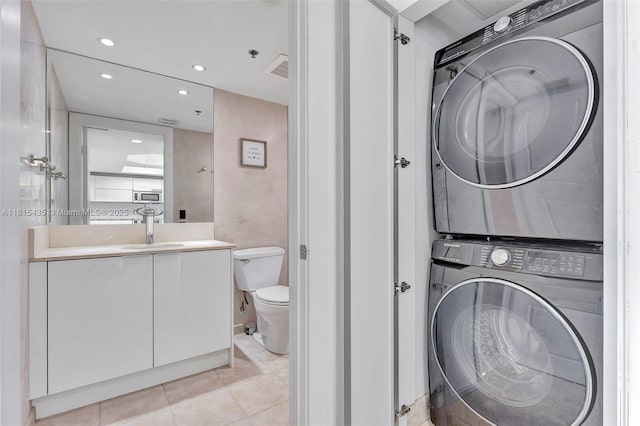 2641 N Flamingo Rd Unit 603N, Sunrise, FL 33323 - bathroom featuring estacked washer and dryer, toilet, vanity, recessed lighting, and tile patterned flooring