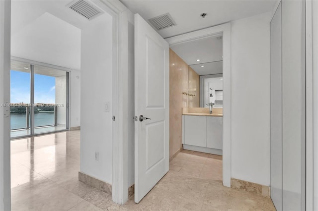 2641 N Flamingo Rd Unit 603N, Sunrise, FL 33323 - corridor featuring light tile patterned flooring, a water view, and baseboards
