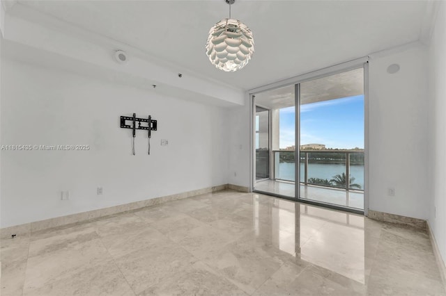 2641 N Flamingo Rd Unit 603N, Sunrise, FL 33323 - spare room featuring expansive windows, baseboards, and a water view