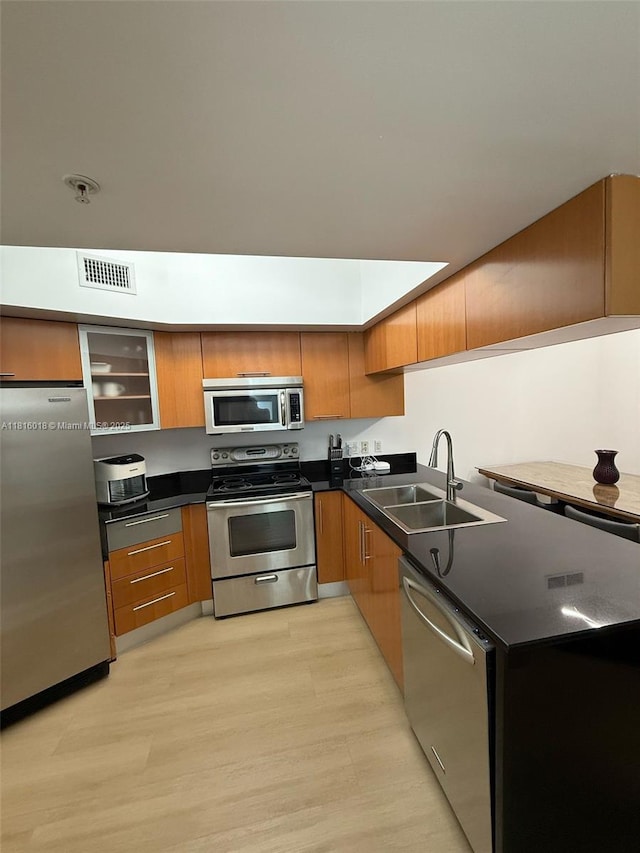 1750 N Bayshore Dr Unit 5401, Miami, FL 33132 - kitchen with appliances with stainless steel finishes, a sink, dark countertops, brown cabinets, and modern cabinets