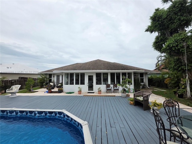 117 SW Fairview Ave, Port St Lucie, FL 34983 - view of pool featuring a wooden deck and a sunroom