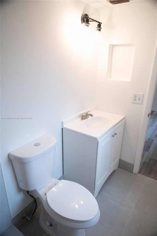 251 NW 76th Ave Unit 208, Margate, FL 33063 - bathroom featuring vanity, toilet, and tile patterned floors