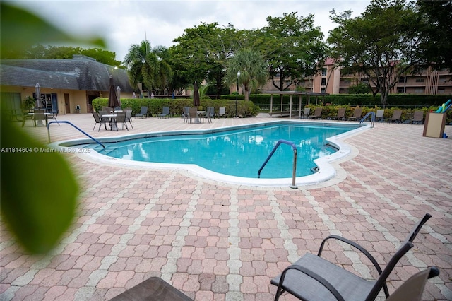 251 NW 76th Ave Unit 208, Margate, FL 33063 - community pool featuring a patio area