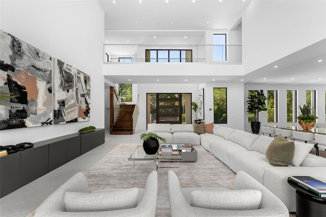 6200 Moss Ranch Rd, Pinecrest, FL 33156 - living room with a high ceiling, healthy amount of natural light, finished concrete floors, stairs, and recessed lighting