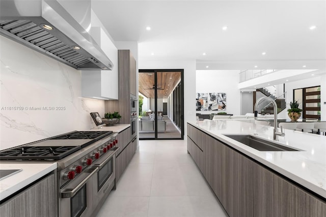 6200 Moss Ranch Rd, Pinecrest, FL 33156 - kitchen with wall chimney range hood, modern cabinets, stainless steel appliances, a sink, and light countertops