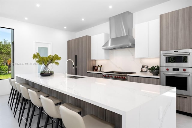 6200 Moss Ranch Rd, Pinecrest, FL 33156 - kitchen featuring wall chimney exhaust hood, a sink, modern cabinets, recessed lighting, and a spacious island