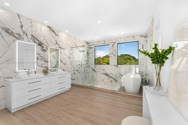 6200 Moss Ranch Rd, Pinecrest, FL 33156 - full bath with a marble finish shower, double vanity, a soaking tub, tile walls, and wood finished floors