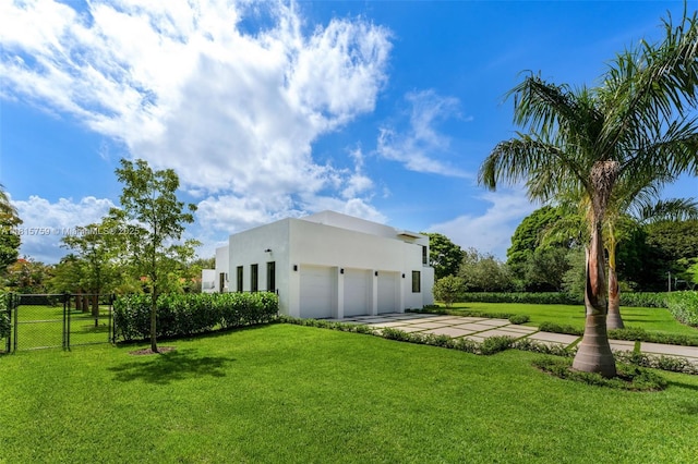 6200 Moss Ranch Rd, Pinecrest, FL 33156 - view of yard with driveway, a garage, and a gate