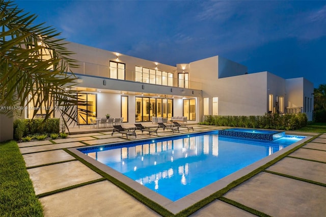 6200 Moss Ranch Rd, Pinecrest, FL 33156 - pool at twilight featuring a patio and a pool with connected hot tub