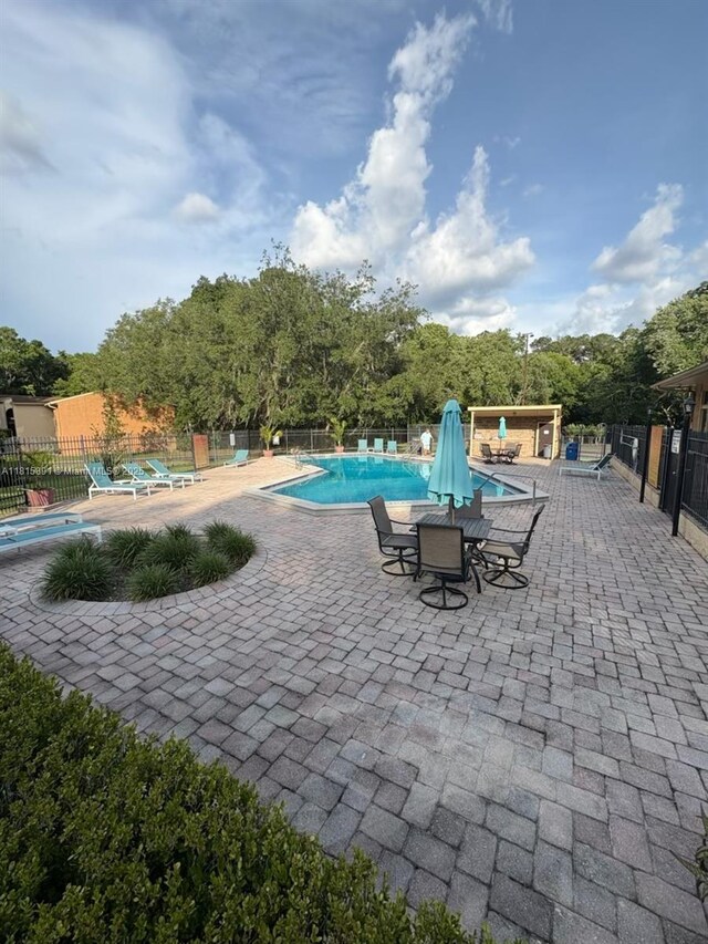1810 NW 23rd Blvd Unit 103, Gainesville, FL 32605 - community pool featuring a patio area