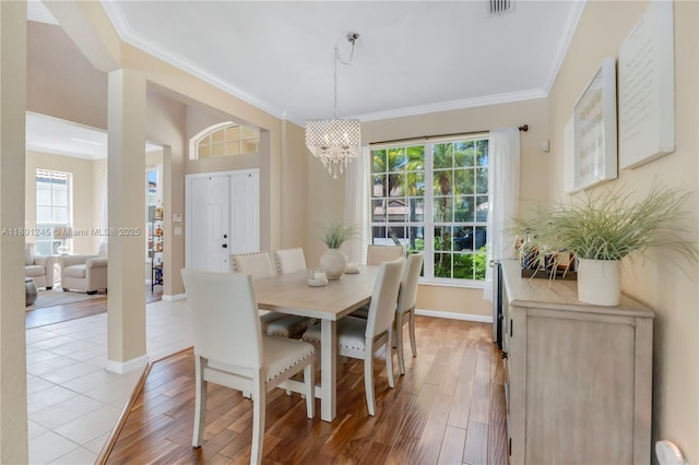 12890 Hyland Cir, Boca Raton, FL 33428 - dining area featuring ornamental molding, baseboards, a chandelier, and light wood-style floors