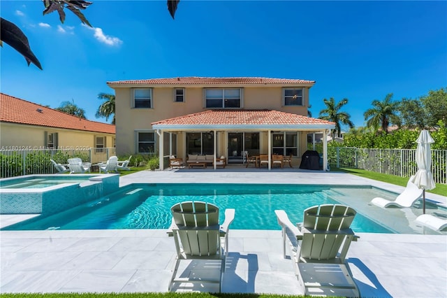 12890 Hyland Cir, Boca Raton, FL 33428 - view of pool with a fenced backyard, a pool with connected hot tub, a patio area, and an outdoor living space