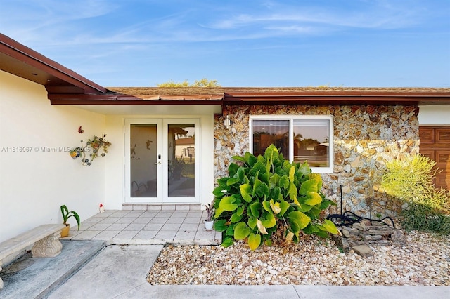 19520 SW 307th St, Homestead, FL 33030 - doorway to property featuring stone siding, stucco siding, and french doors