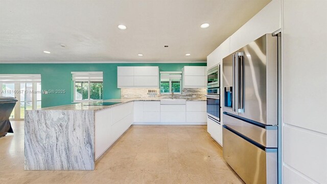 19520 SW 307th St, Homestead, FL 33030 - kitchen featuring appliances with stainless steel finishes, modern cabinets, healthy amount of natural light, a peninsula, and recessed lighting