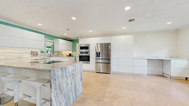 19520 SW 307th St, Homestead, FL 33030 - kitchen featuring stainless steel appliances, light stone countertops, white cabinetry, modern cabinets, and a peninsula