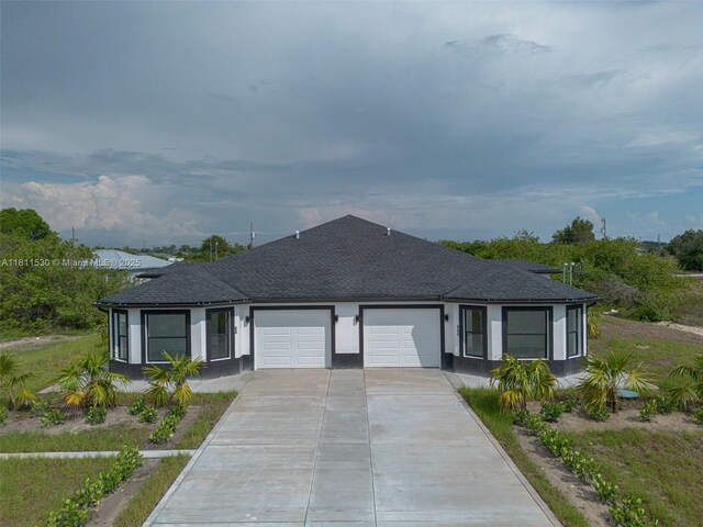 842844 Alabama Rd S, Lehigh Acres, FL 33974 - ranch-style house with an attached garage, driveway, stucco siding, and roof with shingles