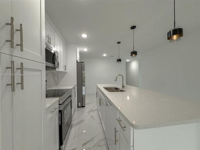 842844 Alabama Rd S, Lehigh Acres, FL 33974 - kitchen featuring stainless steel appliances, a sink, light marble finish floors, a large island with sink, and white cabinets