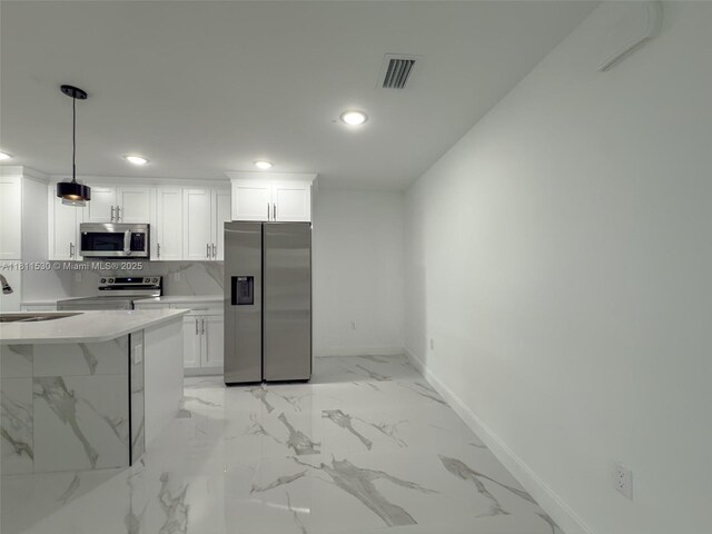 842844 Alabama Rd S, Lehigh Acres, FL 33974 - kitchen featuring stainless steel appliances, baseboards, recessed lighting, a sink, and white cabinetry