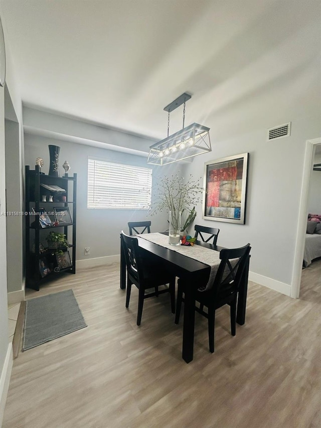 8002 Lagos De Campo Blvd Unit B-107, Tamarac, FL 33321 - dining area with baseboards and light wood-style flooring
