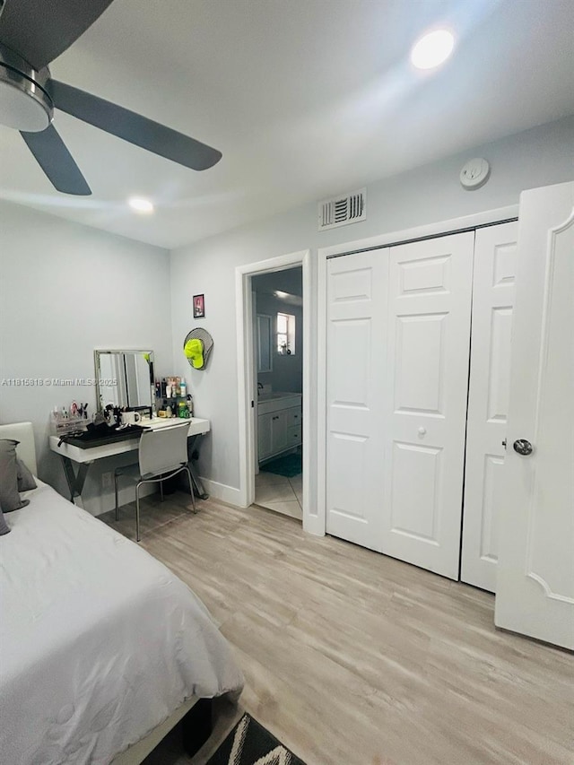 8002 Lagos De Campo Blvd Unit B-107, Tamarac, FL 33321 - bedroom with light wood-style floors, connected bathroom, a ceiling fan, a closet, and baseboards