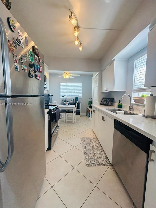 8002 Lagos De Campo Blvd Unit B-107, Tamarac, FL 33321 - kitchen featuring appliances with stainless steel finishes, a sink, white cabinetry, light tile patterned floors, and ceiling fan