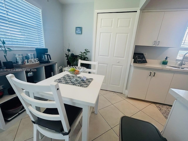 8002 Lagos De Campo Blvd Unit B-107, Tamarac, FL 33321 - kitchen with a sink, white cabinets, light countertops, and light tile patterned floors