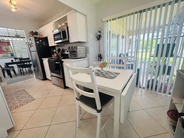 8002 Lagos De Campo Blvd Unit B-107, Tamarac, FL 33321 - kitchen with stainless steel appliances, white cabinets, light tile patterned flooring, and light countertops