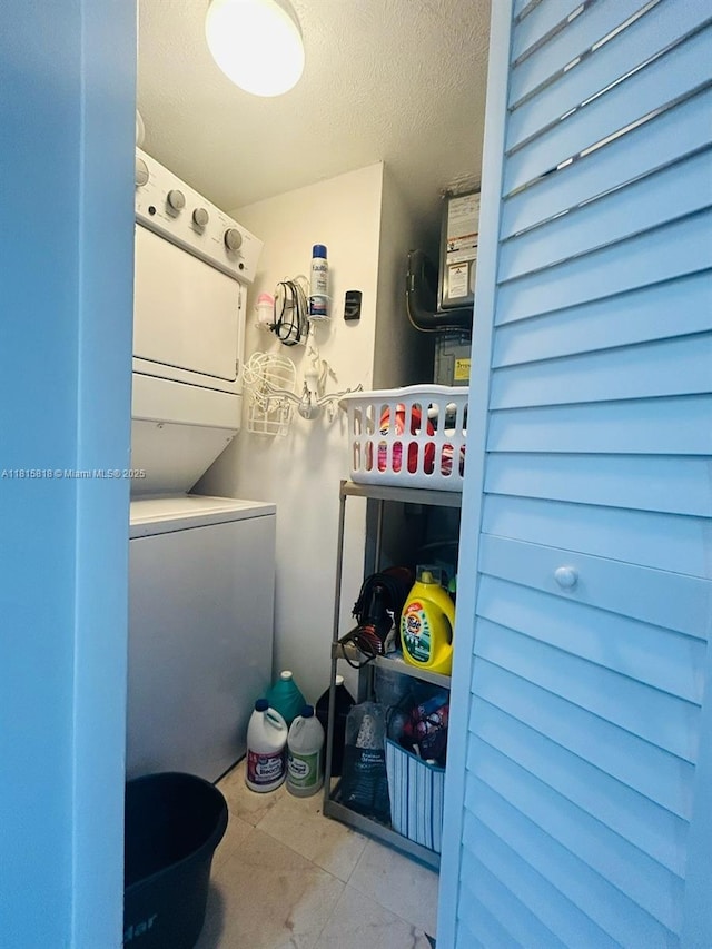 8002 Lagos De Campo Blvd Unit B-107, Tamarac, FL 33321 - laundry area featuring estacked washer and dryer and a textured ceiling