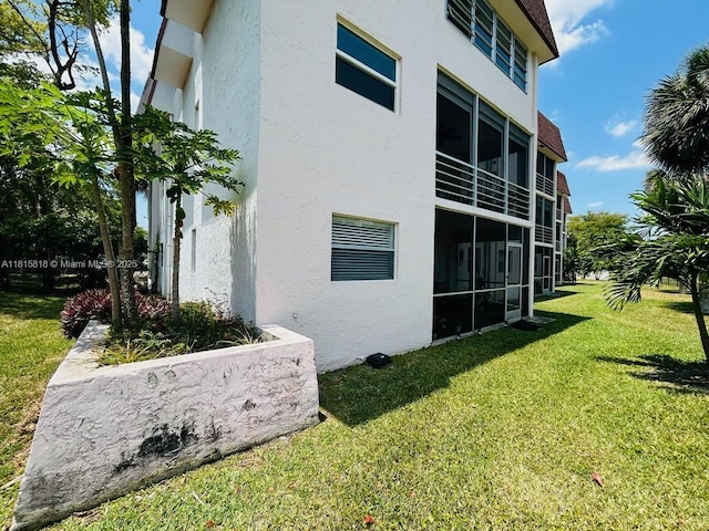 8002 Lagos De Campo Blvd Unit B-107, Tamarac, FL 33321 - view of side of home featuring stucco siding and a lawn