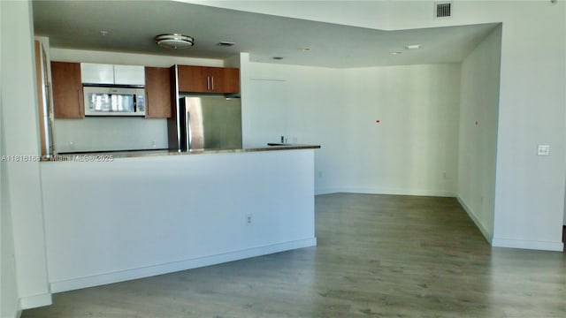 300 S Biscayne Blvd Unit 2705, Miami, FL 33131 - kitchen featuring stainless steel appliances, wood finished floors, a peninsula, and brown cabinets