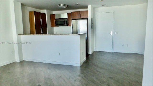 300 S Biscayne Blvd Unit 2705, Miami, FL 33131 - kitchen with stainless steel appliances, wood finished floors, light countertops, and baseboards