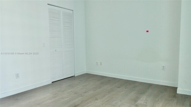 300 S Biscayne Blvd Unit 2705, Miami, FL 33131 - unfurnished bedroom with wood finished floors and a closet