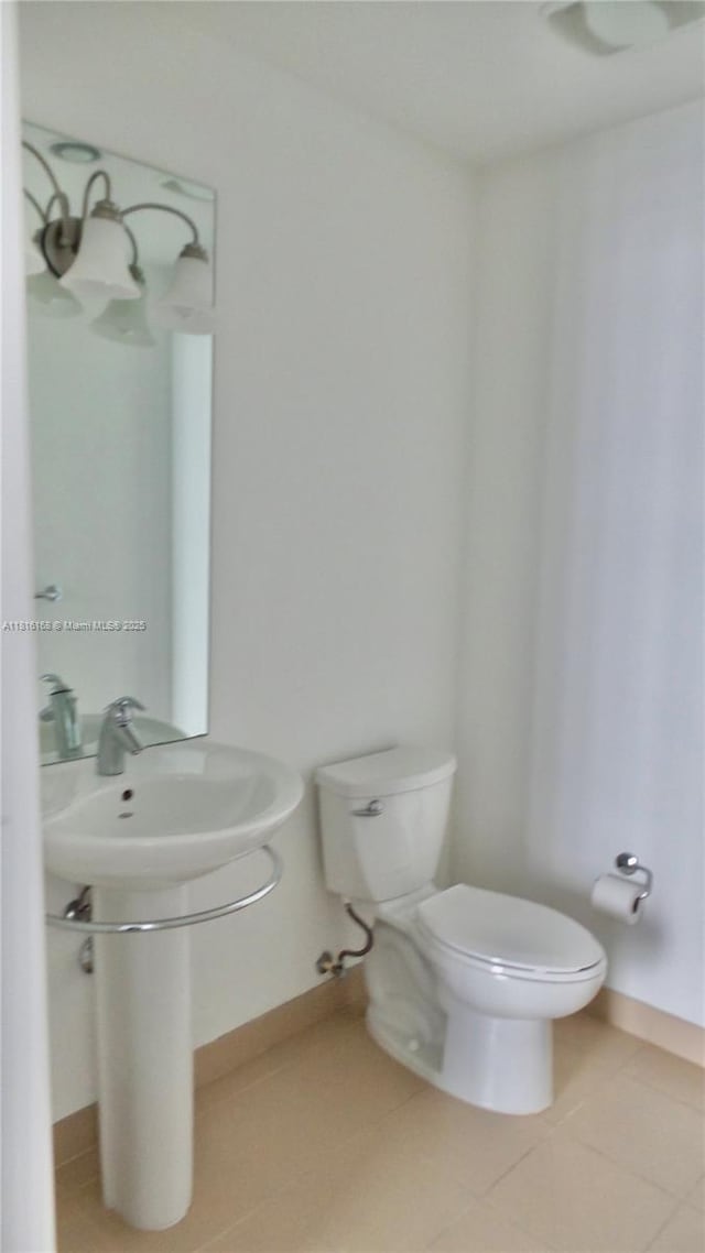 300 S Biscayne Blvd Unit 2705, Miami, FL 33131 - bathroom with tile patterned flooring, toilet, and baseboards